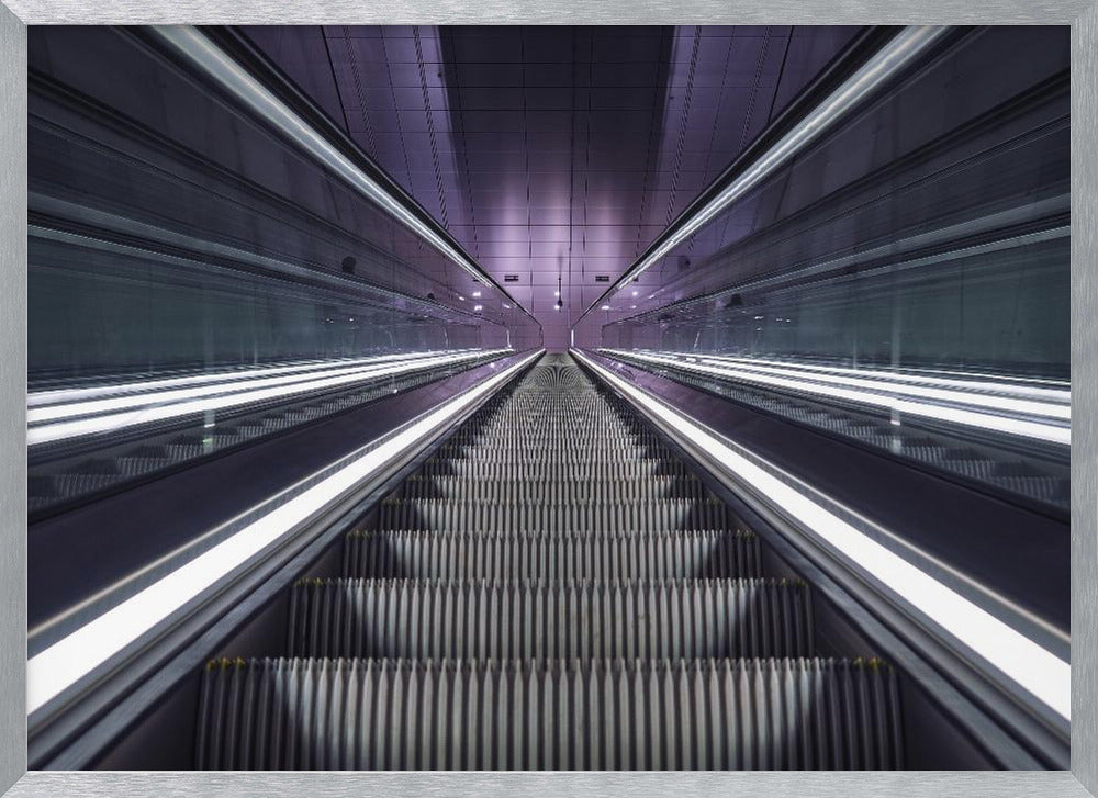 A symmetrical, first-person view looking down a long, empty escalator in a modern subway station, with bright white lights lining the handrails and a purple glow on the ceiling, creating a futuristic and infinite perspective. Wall Art