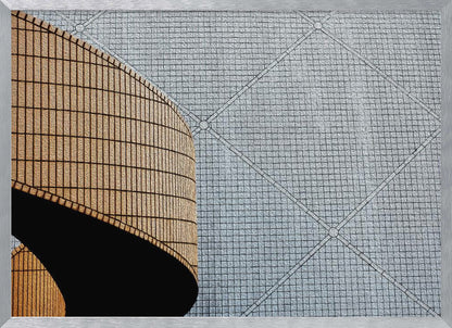 An abstract architectural image with a painterly texture, framed in gray. The composition features a curved wall of vertical brown tiles on the left, casting a sharp black shadow, juxtaposed with a flat surface of gray square tiles arranged in a grid with diagonal lines on the right. Artwork