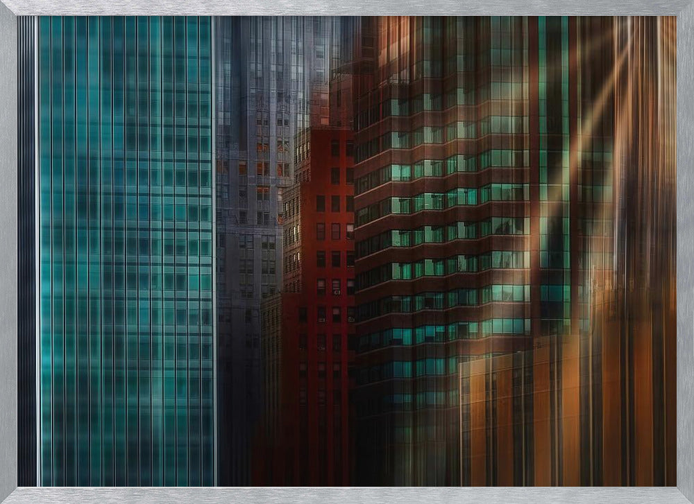 An abstract cityscape artwork in a silver frame, featuring a teal glass skyscraper on the left transitioning to red and brown buildings on the right with a strong vertical motion blur effect, creating a dynamic sense of movement. Decor