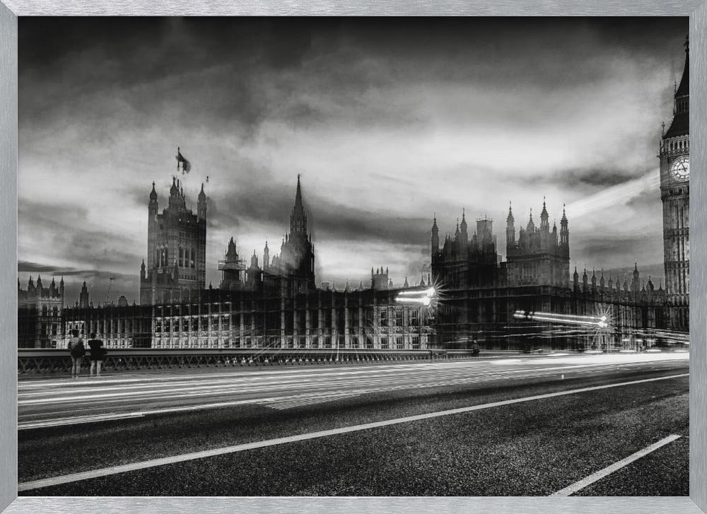 A framed, black and white long-exposure photograph of the Houses of Parliament and Big Ben in London. The view is from a bridge, with streaks of white light from traffic blurring across the road in the foreground under a dramatic, cloudy sky. Wall Art