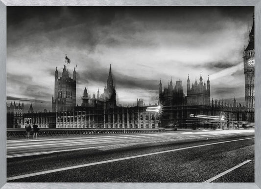 A framed, black and white long-exposure photograph of the Houses of Parliament and Big Ben in London. The view is from a bridge, with streaks of white light from traffic blurring across the road in the foreground under a dramatic, cloudy sky. Wall Art