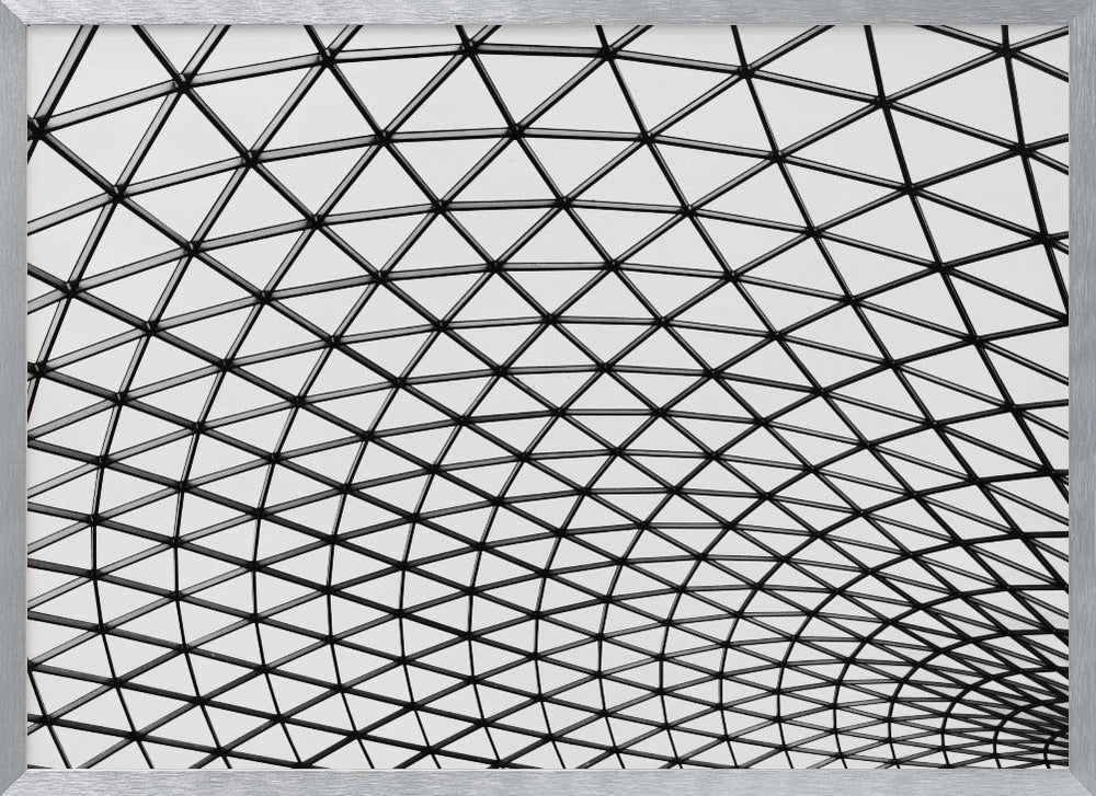A framed, black and white photograph of a modern architectural dome ceiling. The image is a close-up, looking up at the intricate metal framework that creates a repeating pattern of triangles against the bright glass panels. Poster