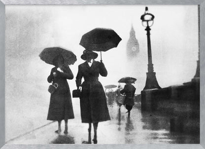 A vintage black and white photograph of people with umbrellas walking on a wet, foggy day in London. The silhouettes of the people are dark against the misty background, where the faint outline of Big Ben and a street lamp are visible. Wall Art