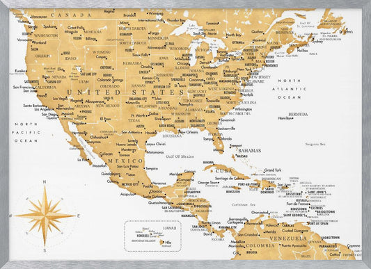 A stylized map of North and Central America and the Caribbean, featuring gold-colored landmasses on a light gray, textured background. Countries, states, and major cities are labeled in black text. A compass rose is shown in the lower-left corner. The entire map is enclosed in a light gray frame. Decor