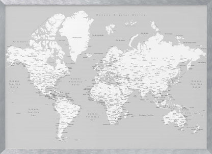 A detailed world map in Spanish with a monochromatic color scheme, framed in a light gray wooden frame. The continents are shown in white on a light gray ocean background, with countries and numerous cities labeled in black text. Artwork