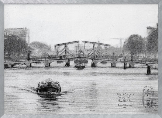 A framed black and white pencil drawing of the Magere Brug, a famous bridge in Amsterdam. The drawbridge is depicted over a canal with a boat in the foreground, creating a classic European city scene. Wall Art