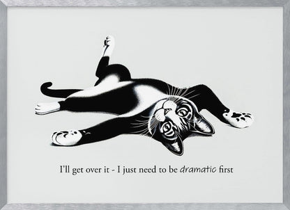 A framed black and white illustration of a tuxedo cat lying playfully on its back. Below the image is the text, 'I'll get over it - I just need to be dramatic first'. Artwork