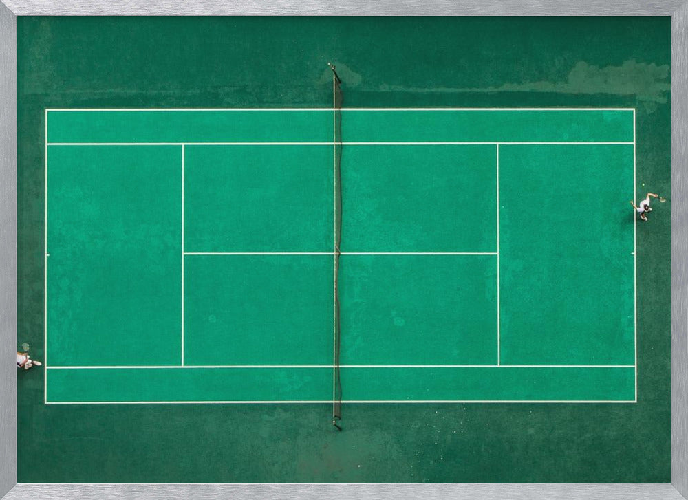 An aerial top-down photograph of a vibrant green tennis court with two players in the middle of a game, one on the far left and the other on the far right, all enclosed within a brushed silver frame. Print
