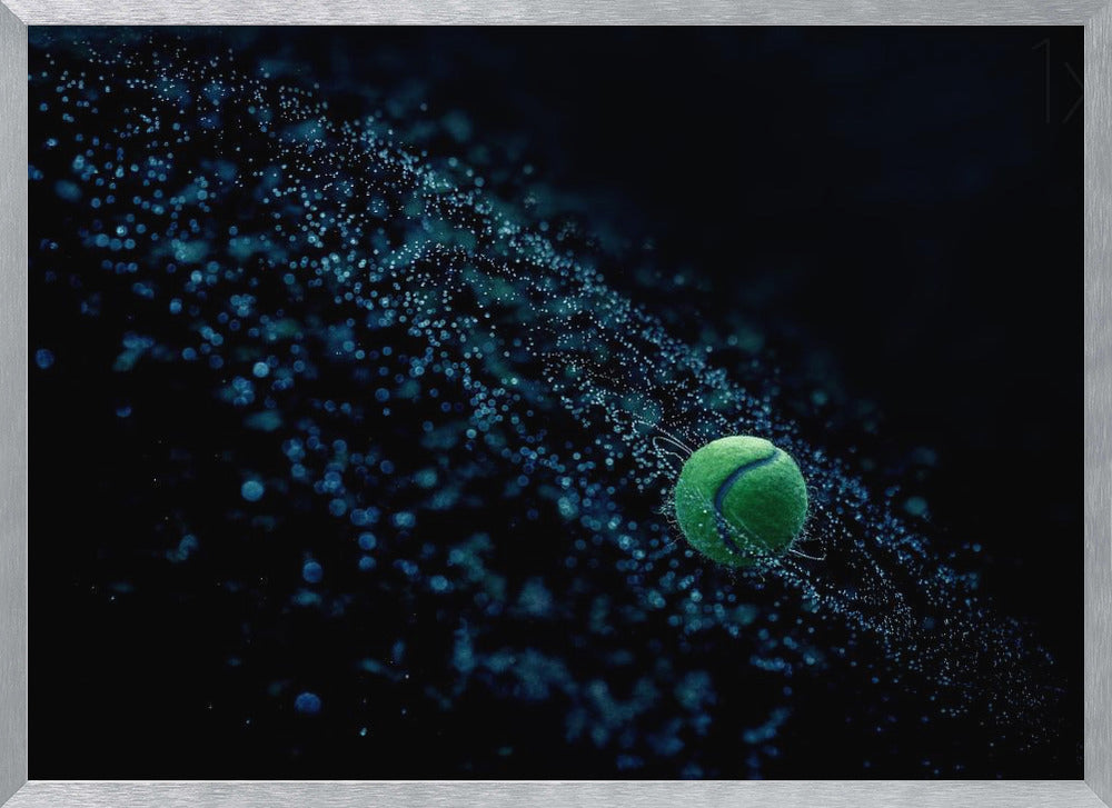 A high-speed photograph captures a spinning green tennis ball against a black background, with a dramatic spray of blue-lit water droplets flying off it in a cosmic-like spiral. Artwork