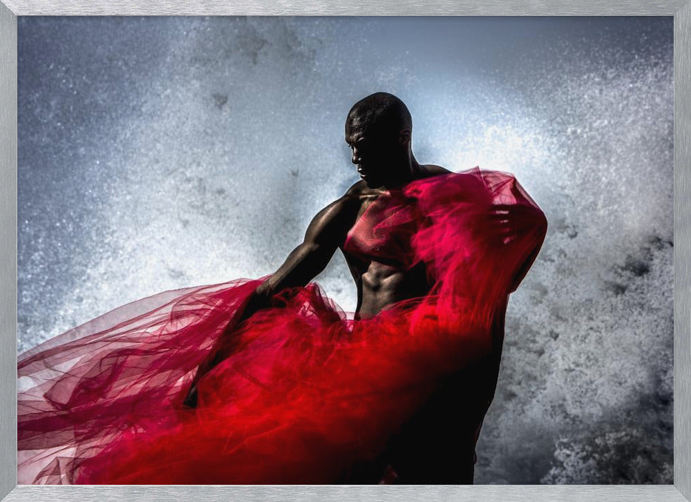 A dramatic photograph of a muscular Black man, mostly in shadow, holding a voluminous, sheer red fabric against a backdrop of splashing white water. The image is encased in a silver frame. Poster