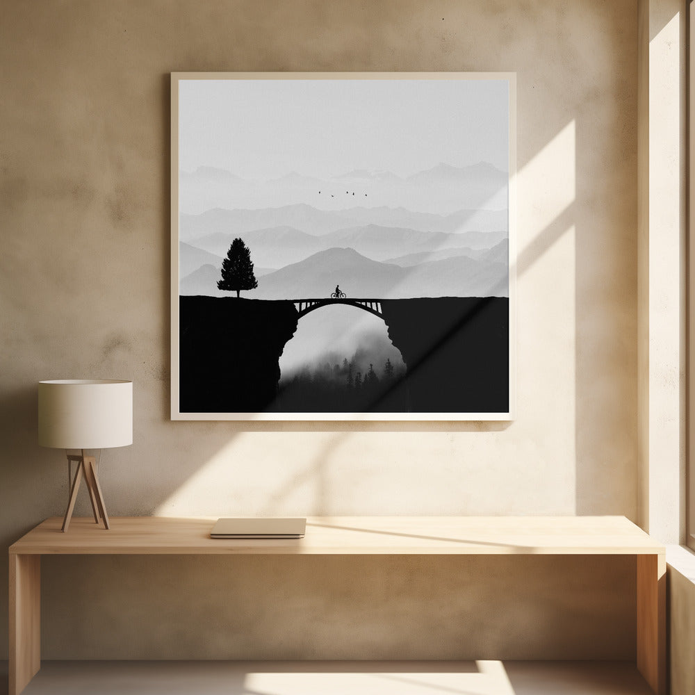A minimalist black and white artwork featuring the silhouette of a cyclist crossing a high arched bridge between two cliffs. A lone tree stands on one cliff, while layers of misty mountains fill the background, creating a sense of depth and solitude. Poster