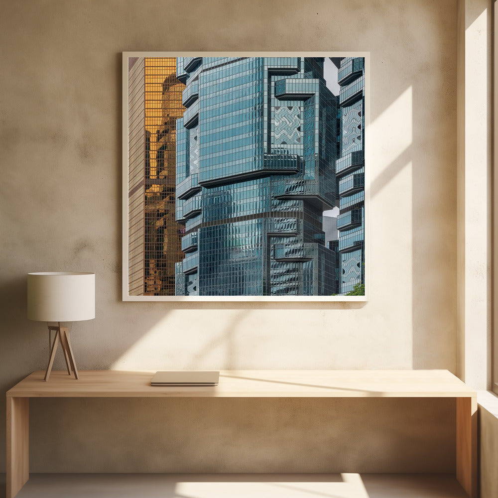 A framed close-up photograph of modern architecture, featuring a golden grid-patterned skyscraper next to a complex blue glass building with jutting levels and distorted reflections. Wall Art