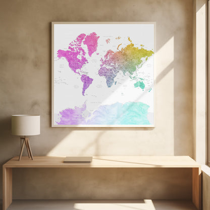 A framed art print of a world map featuring a colorful watercolor effect. The continents are painted in a rainbow gradient, transitioning from pink and purple in the Americas to yellow, green, and teal across Europe, Asia, Australia, and Antarctica, all set against a clean white background. Print