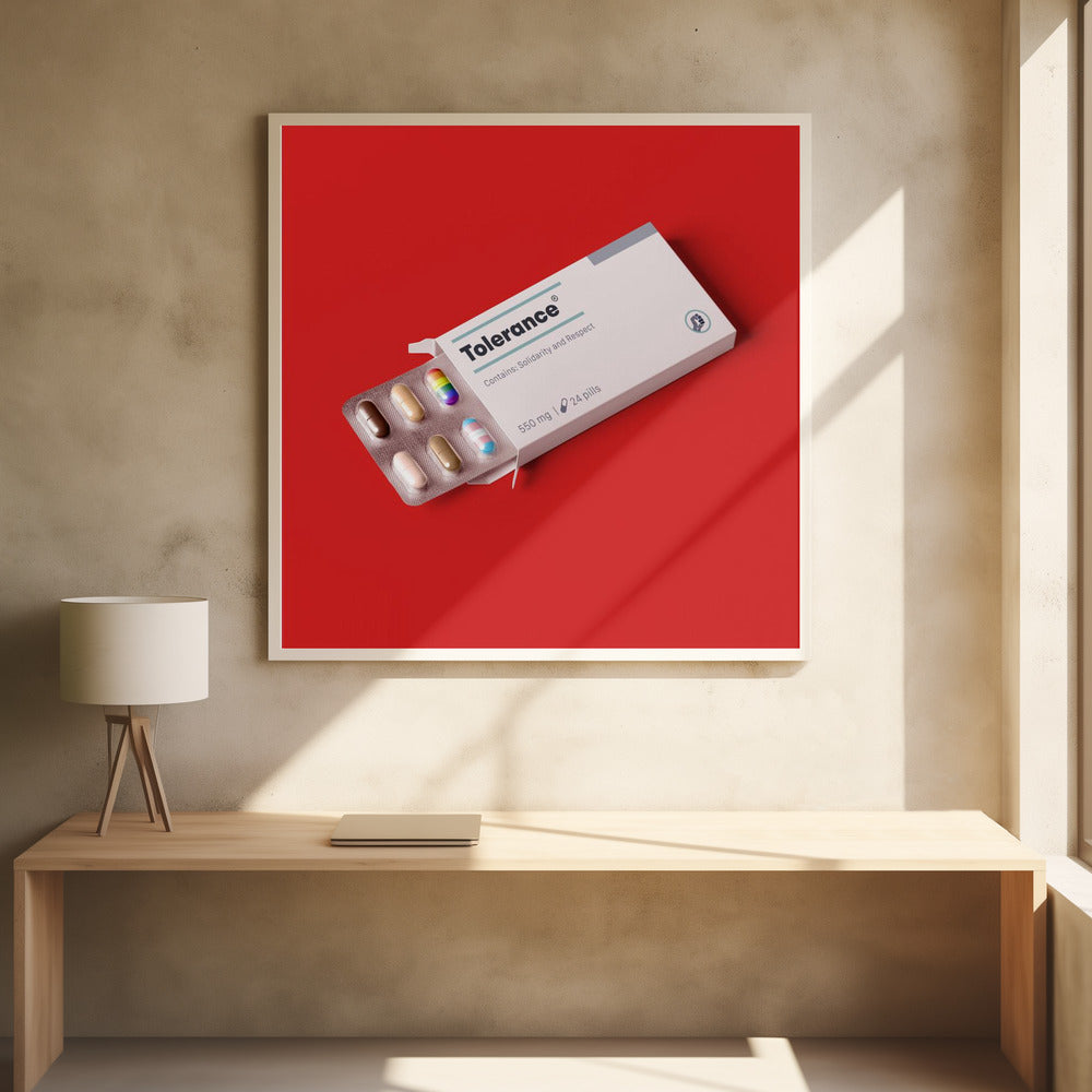 A framed conceptual art piece on a bright red background. It features a white medicine box labeled 'Tolerance', with a blister pack of pills emerging. Most pills are in various skin tones, but one is a rainbow pride flag and another is a transgender pride flag. Artwork