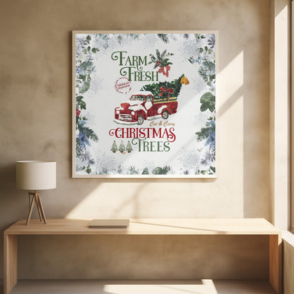 A vintage-style Christmas art print in a light wood frame. It features a watercolor illustration of a classic red pickup truck carrying a Christmas tree, with snow on its hood and roof. The text reads 'Farm Fresh Cut & Carry Christmas Trees' in festive green and red fonts. The background is white with a decorative border of frosted greenery and snowflakes. Wall Art