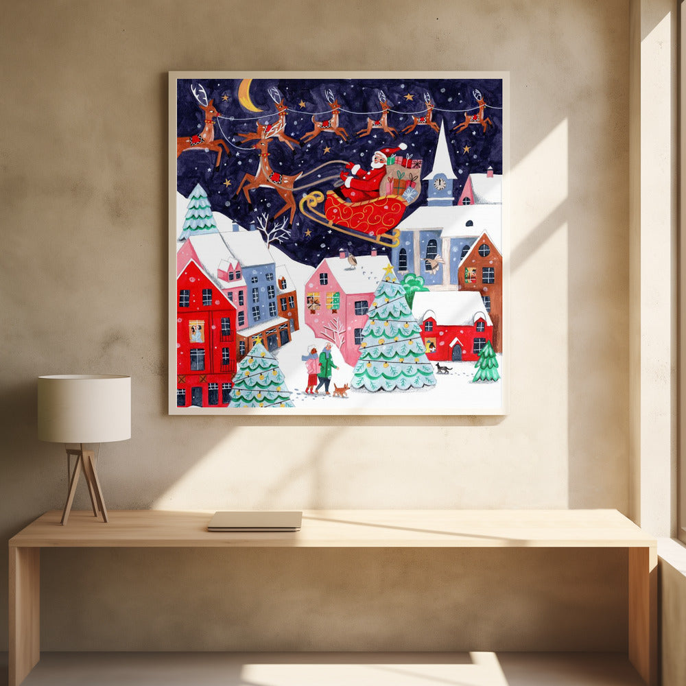 A festive illustration of Santa Claus flying in his sleigh pulled by reindeer over a snowy European-style village at night. The sky is a deep starry blue with a crescent moon, and the houses below are painted in vibrant reds, pinks, and blues, with warm light in the windows. People walk in the snow near decorated Christmas trees. Decor