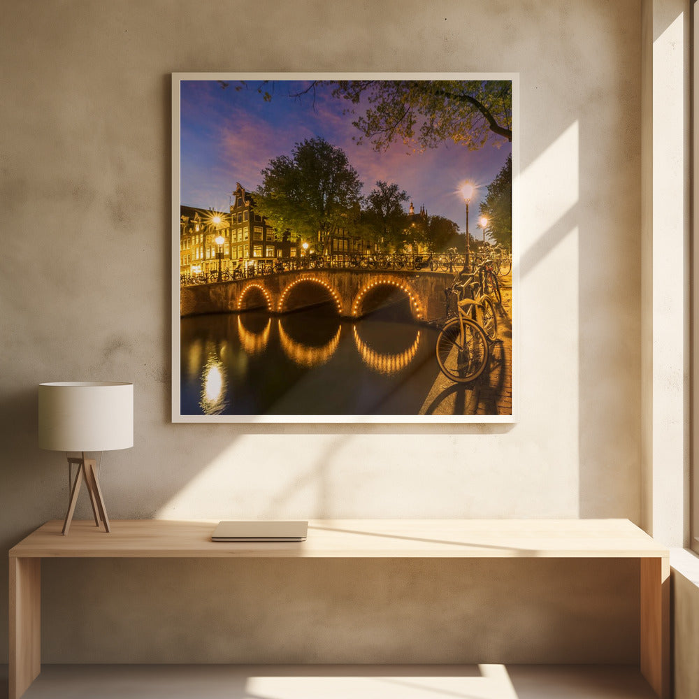 An idyllic nightscape view of Keizersgracht canal in Amsterdam, featuring illuminated buildings reflecting on the water under a dark sky. Wall Art