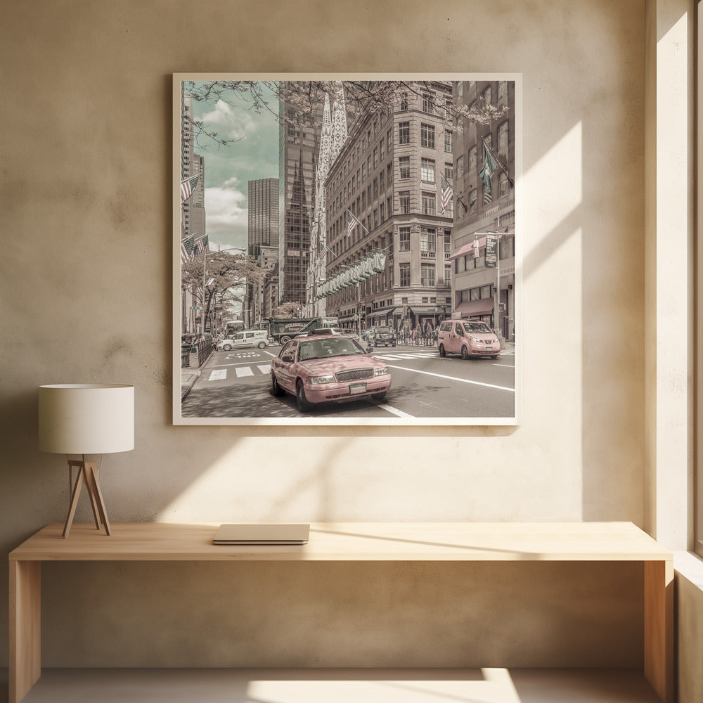 A framed photograph of a busy New York City street with a vintage, sepia-toned filter. Two cars, one in the foreground and one in the midground, are selectively colored a dusty pink, contrasting with the muted tones of the surrounding skyscrapers, American flags, and pedestrians. The sky is a pale teal color. Poster