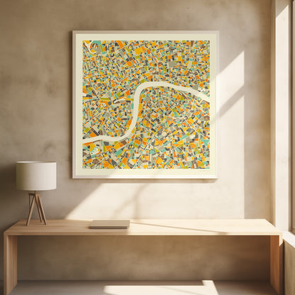A framed, abstract map of London featuring a colorful mosaic of city blocks in orange, yellow, teal, and brown, with the River Thames winding through the center in a wide, cream-colored band. Poster