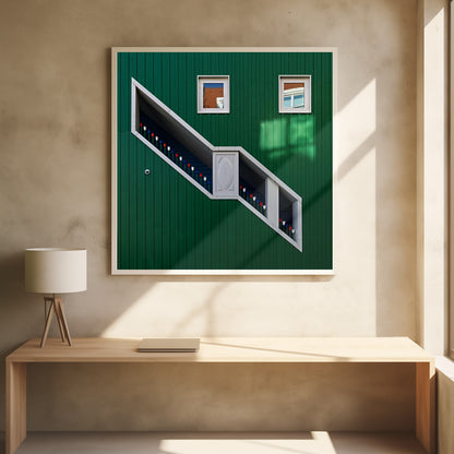 A framed photograph of a modern building with a dark green vertical-paneled facade, featuring a large, white-framed diagonal window that resembles a staircase, decorated with small red, white, and blue tulips. Two small square windows are positioned above. Decor
