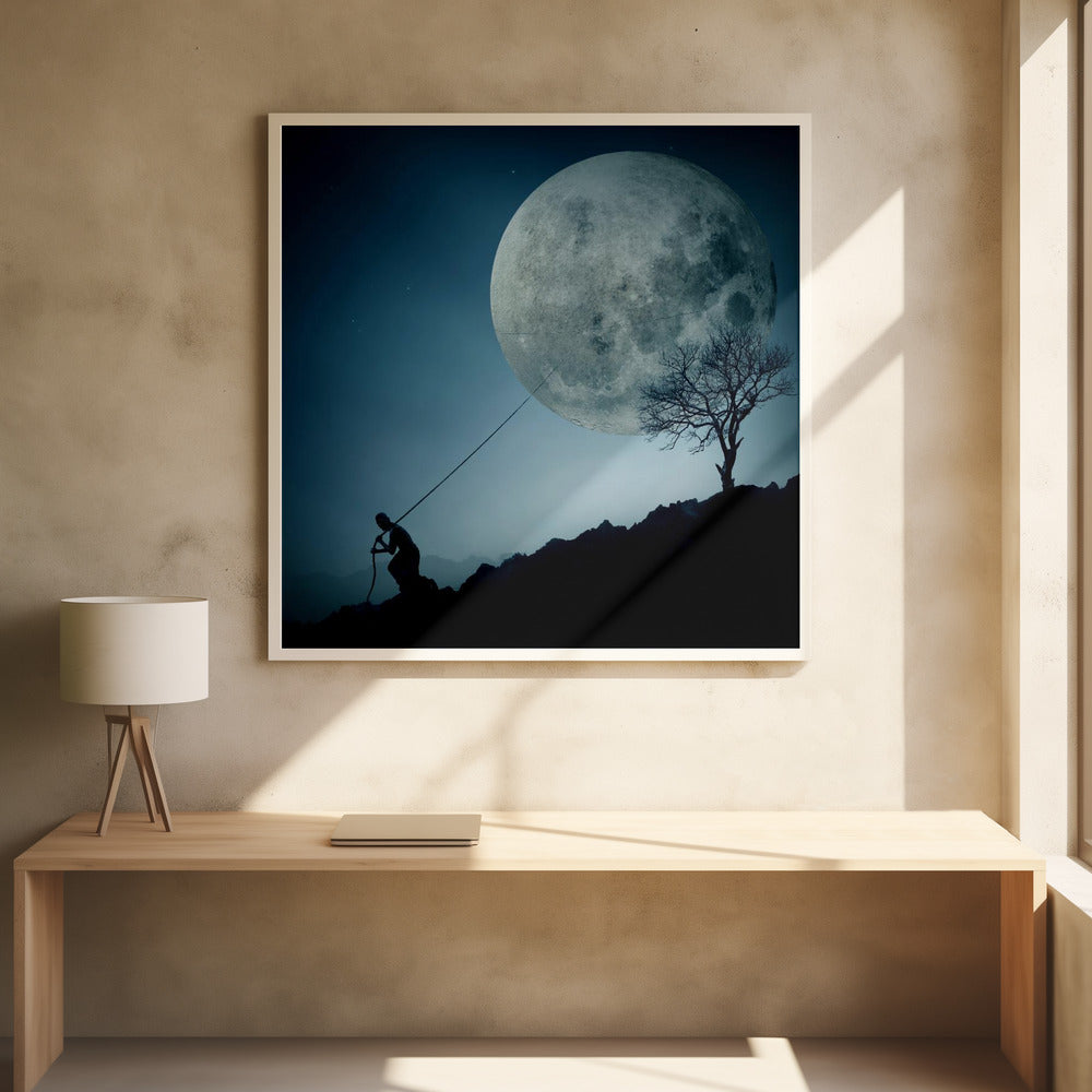 A surreal, framed artwork depicting a silhouette of a person on a dark, rocky hill at night, pulling a rope attached to a massive, detailed full moon, seemingly trying to pull it from the dark blue, star-dusted sky. A bare, silhouetted tree stands on the same hill. Artwork